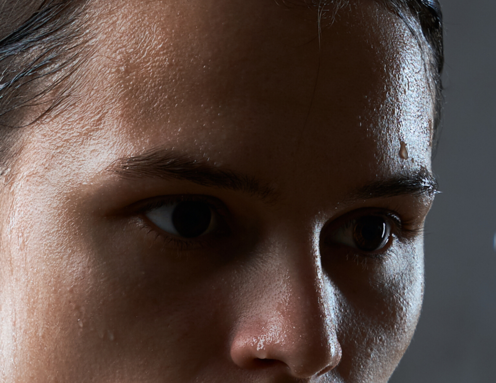 Woman with sweat on forehad