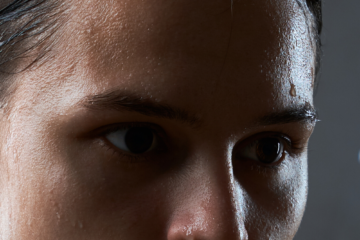 Woman with sweat on forehad
